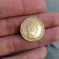 Moneda extraña de 1847 con los rostros de Luis Felipe 1 y Regina victoria